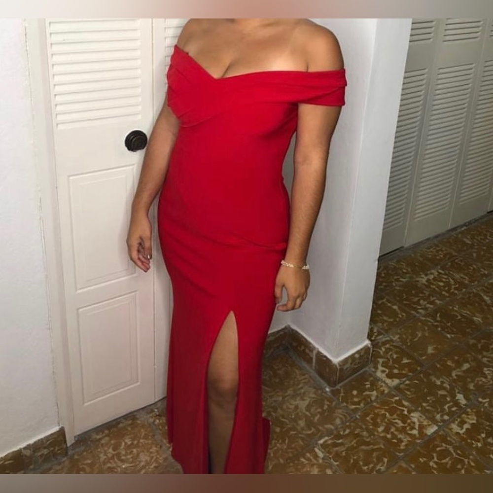 Red sleeveless floor length dress.